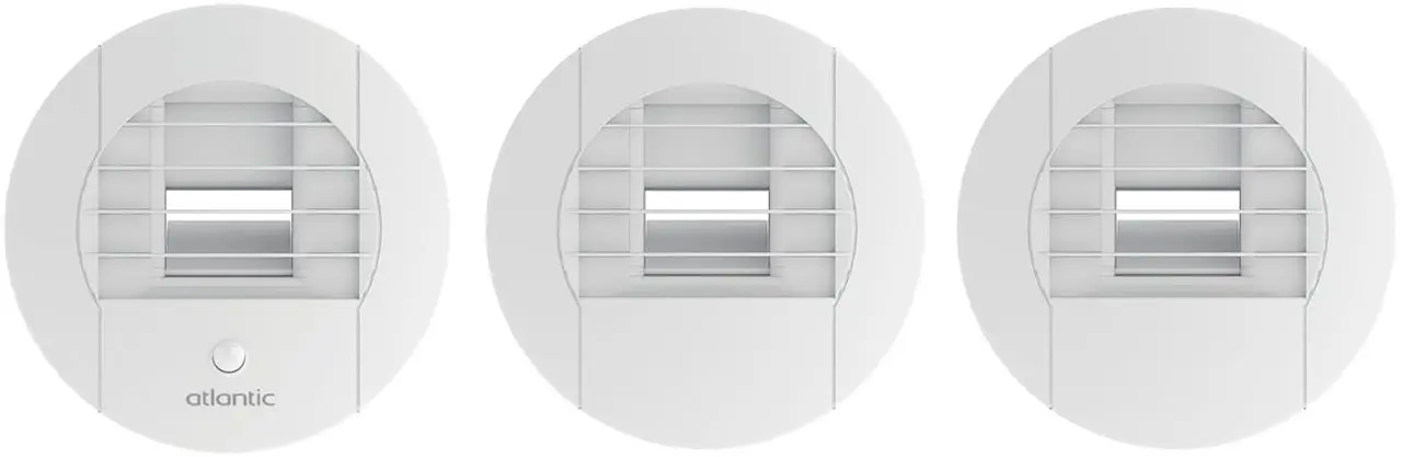 Trois bouches d'extraction rondes de ventilation mécanique, façade blanche à grille réglable