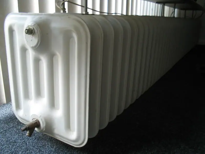Radiateur installé dans une pièce de vie sous une allège